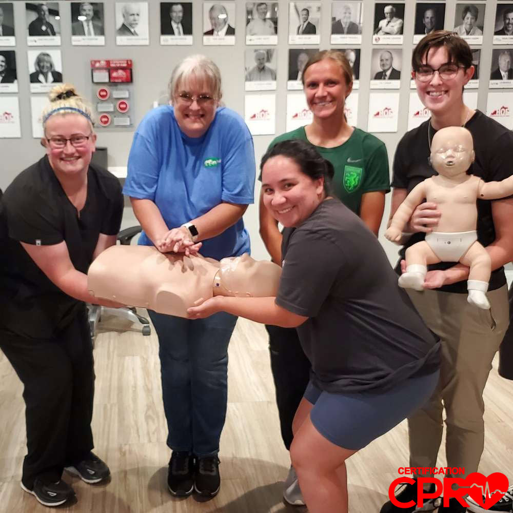CPR training class in Jacksonville with students practicing on mannequins.